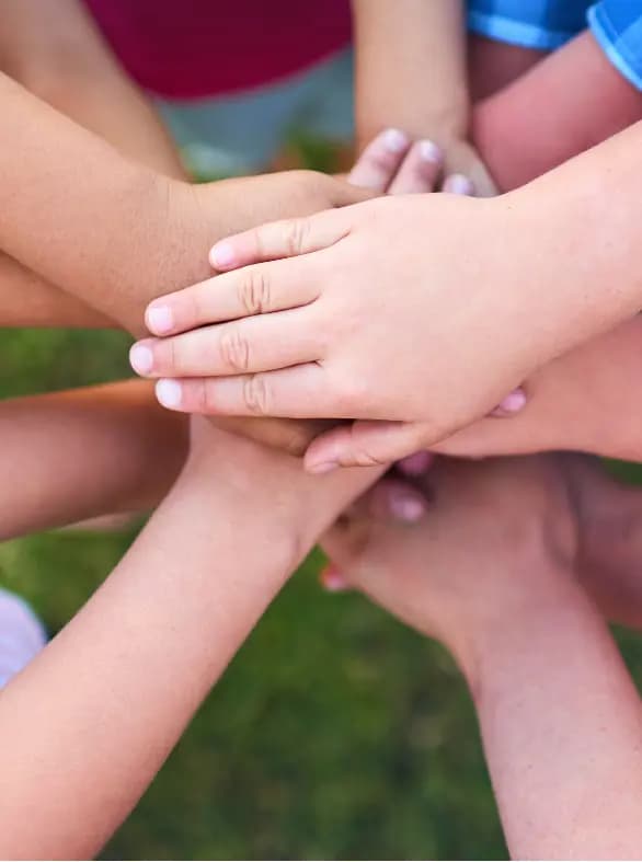Diverse hands stacked together in unity